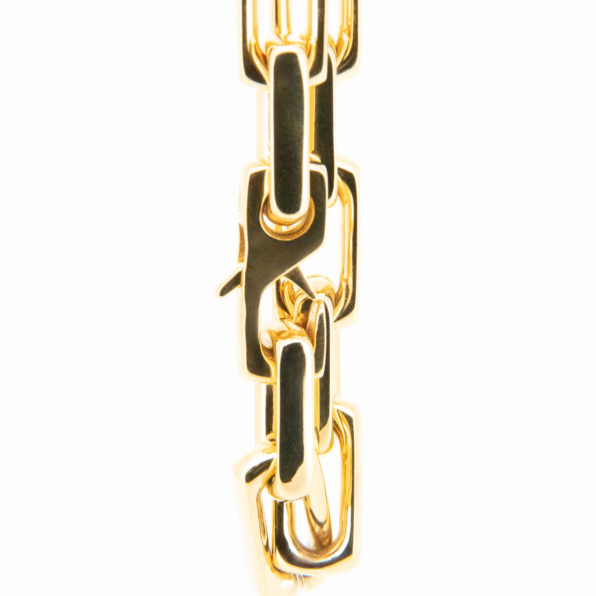 Gold chain link with black enamel inlay.