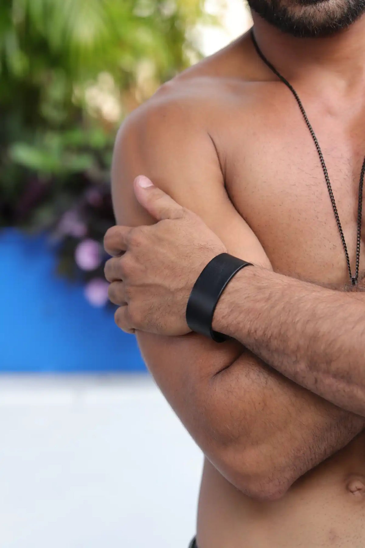 Black fitness tracker worn on a muscular arm.
