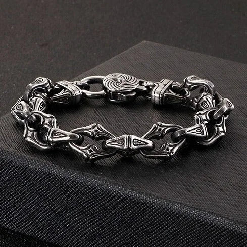 Ornate silver bracelet with intricate Gothic-style links and a spiral clasp.