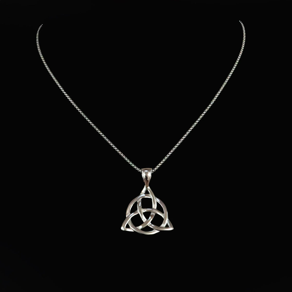 Silver pendant necklace featuring a Celtic triquetra knot design.