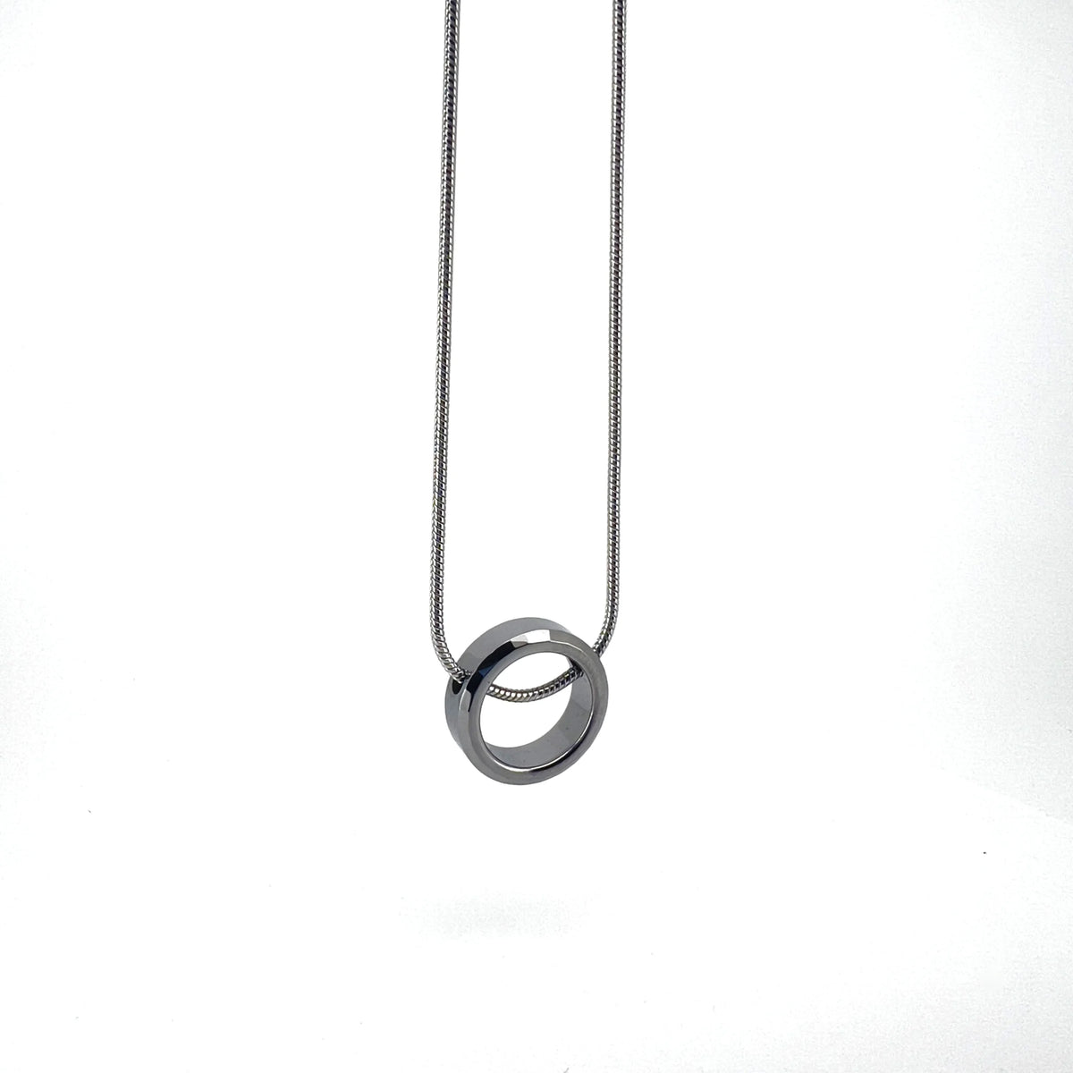 Silver ring pendant on a thin chain necklace.