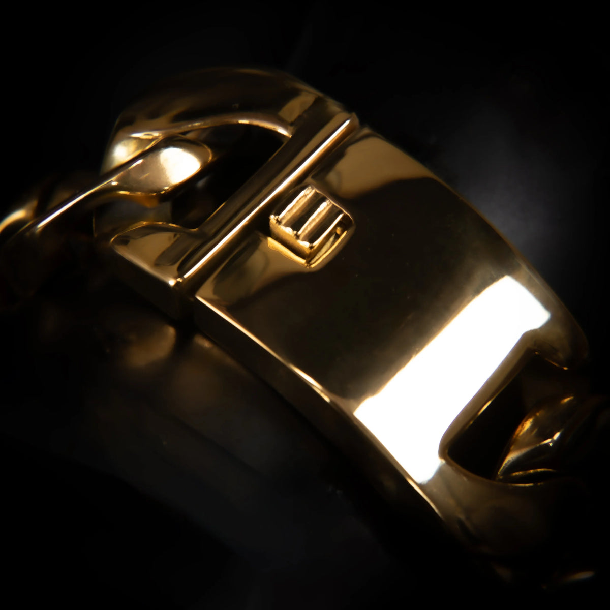 Gold-colored metal watch clasp or bracelet fastener with a sleek, modern design.