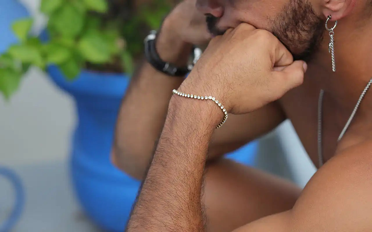 Silver beaded bracelet worn on a wrist.