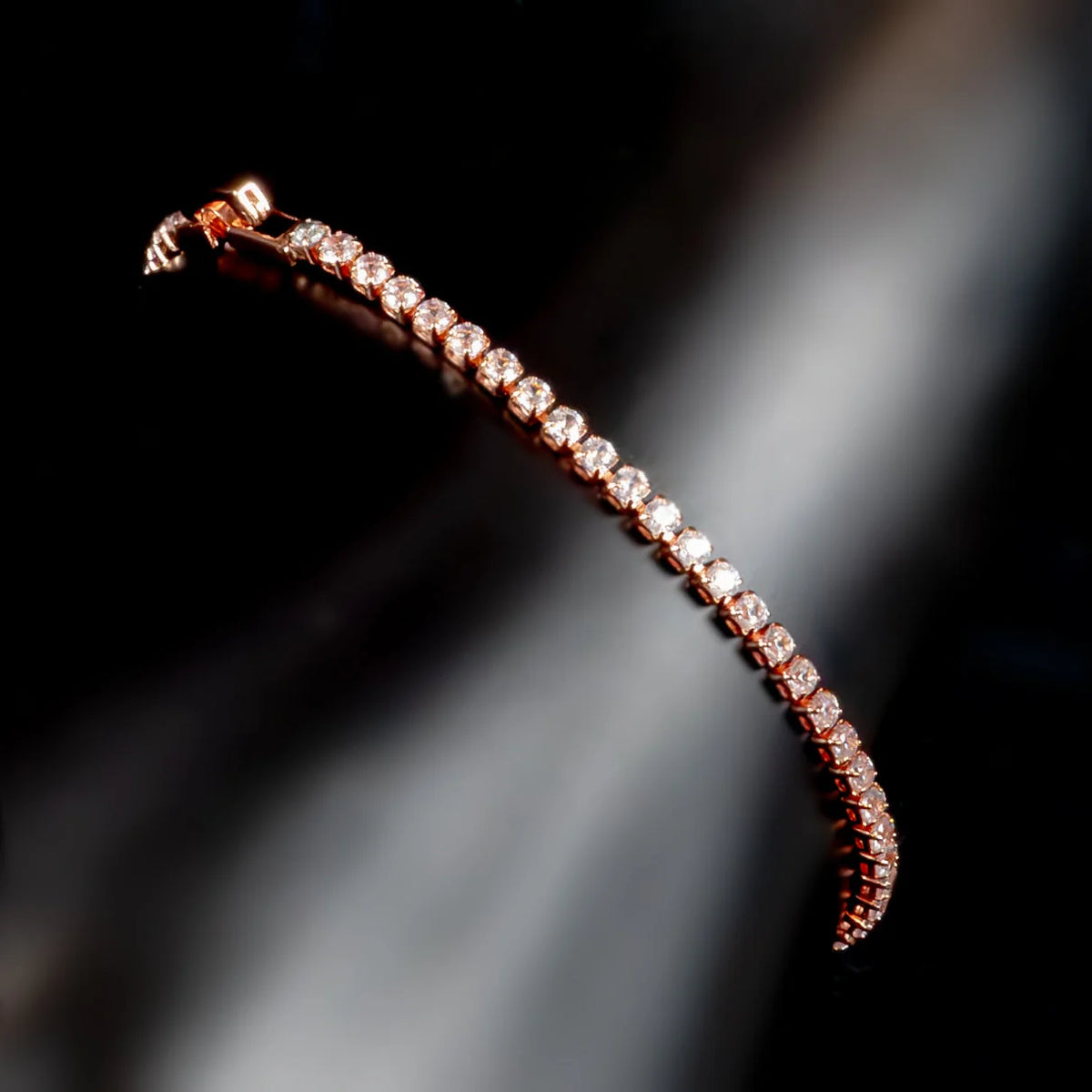 Diamond tennis bracelet with rose gold setting.