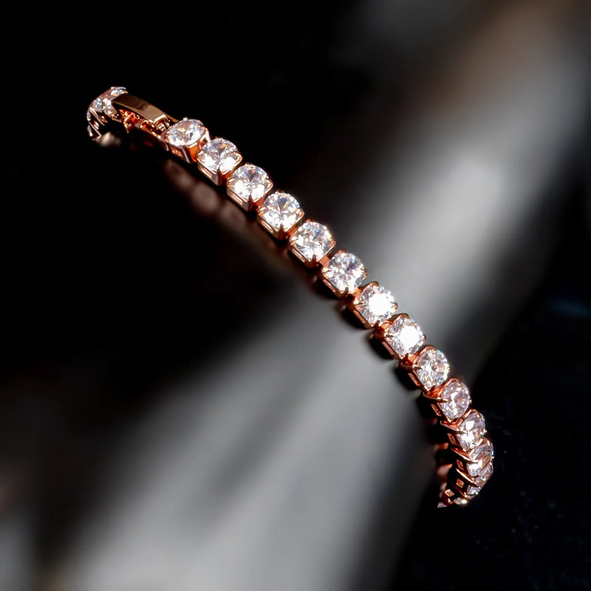 Rose gold bracelet or bangle adorned with a line of sparkling diamonds.