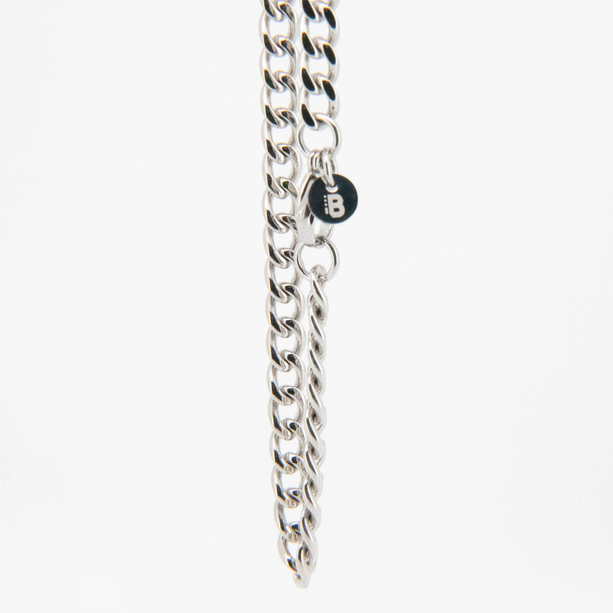 Silver metal chain necklace with a small round charm.