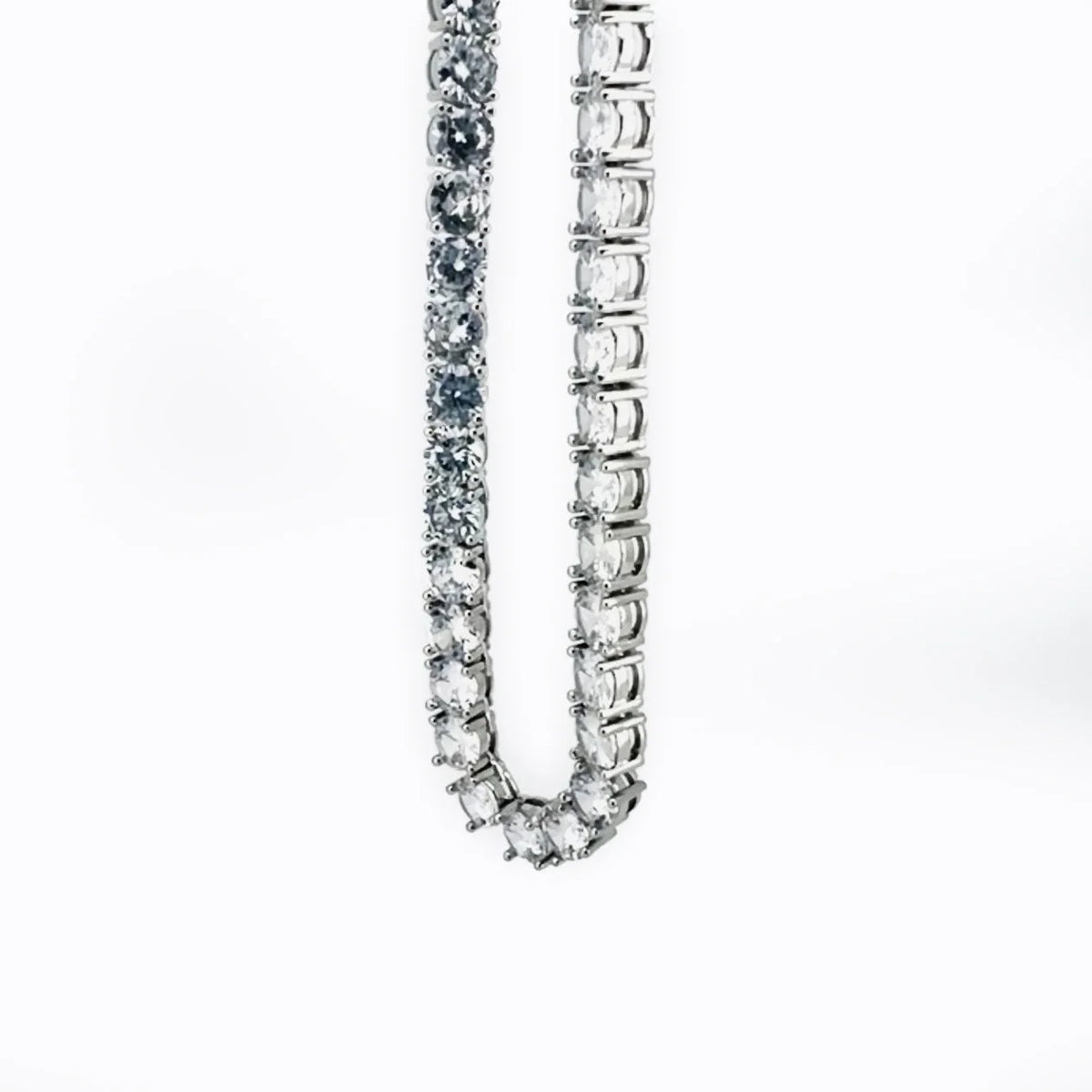 Diamond tennis necklace or bracelet with a continuous line of sparkling stones set in a silver or white gold chain.