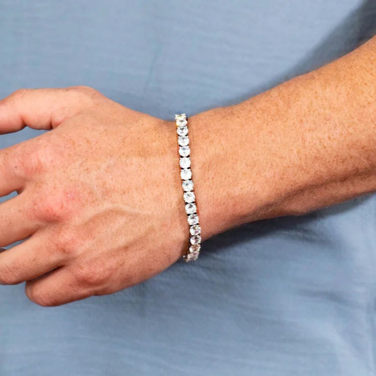 Diamond tennis bracelet worn on a wrist.