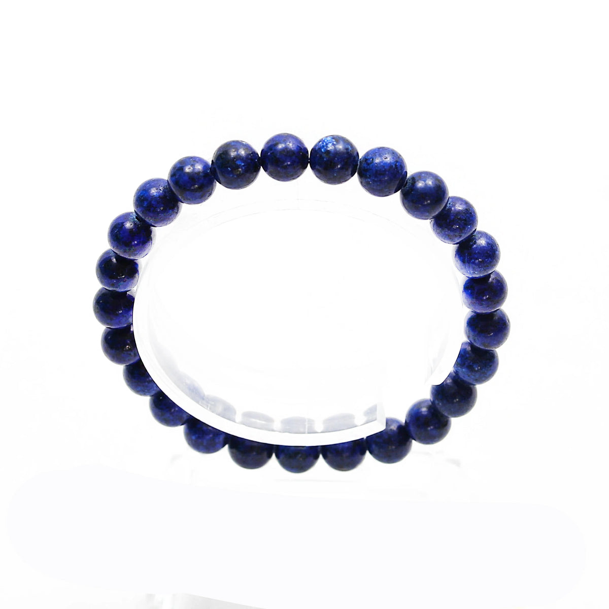 Blue lapis lazuli bead bracelet on a white surface.