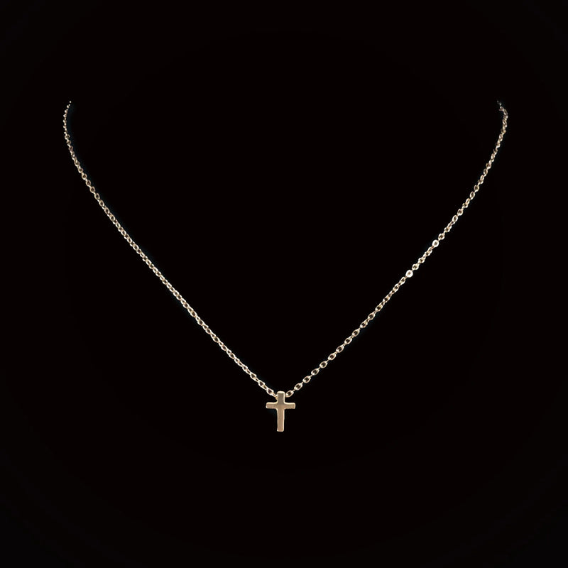 Delicate silver chain necklace with a small cross pendant.