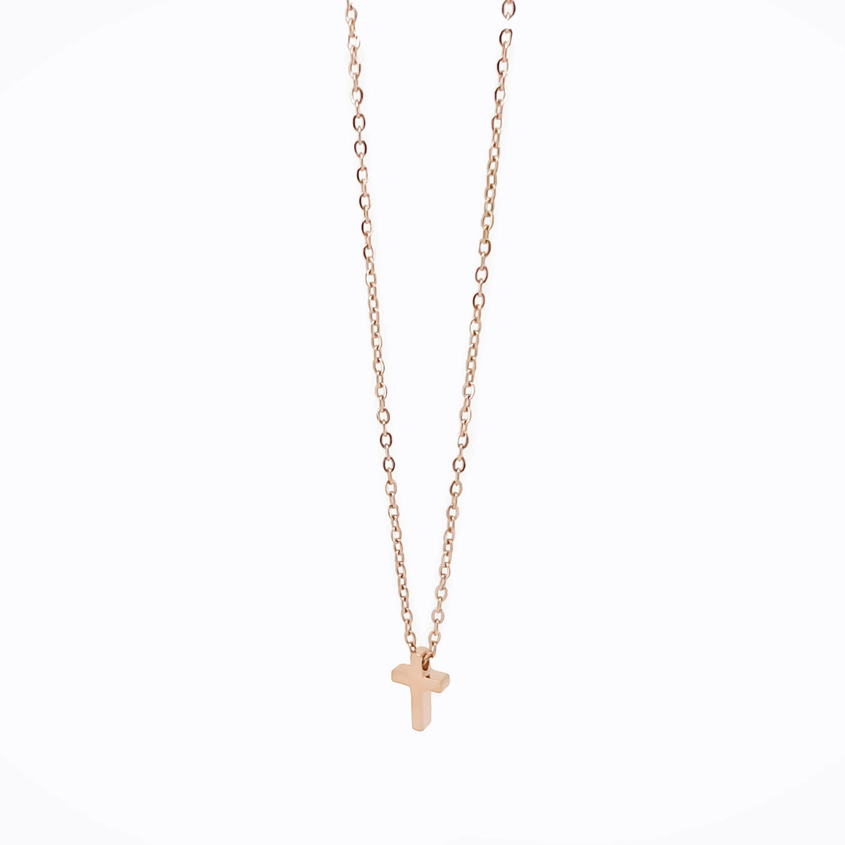 Gold-colored necklace with a small cross pendant.