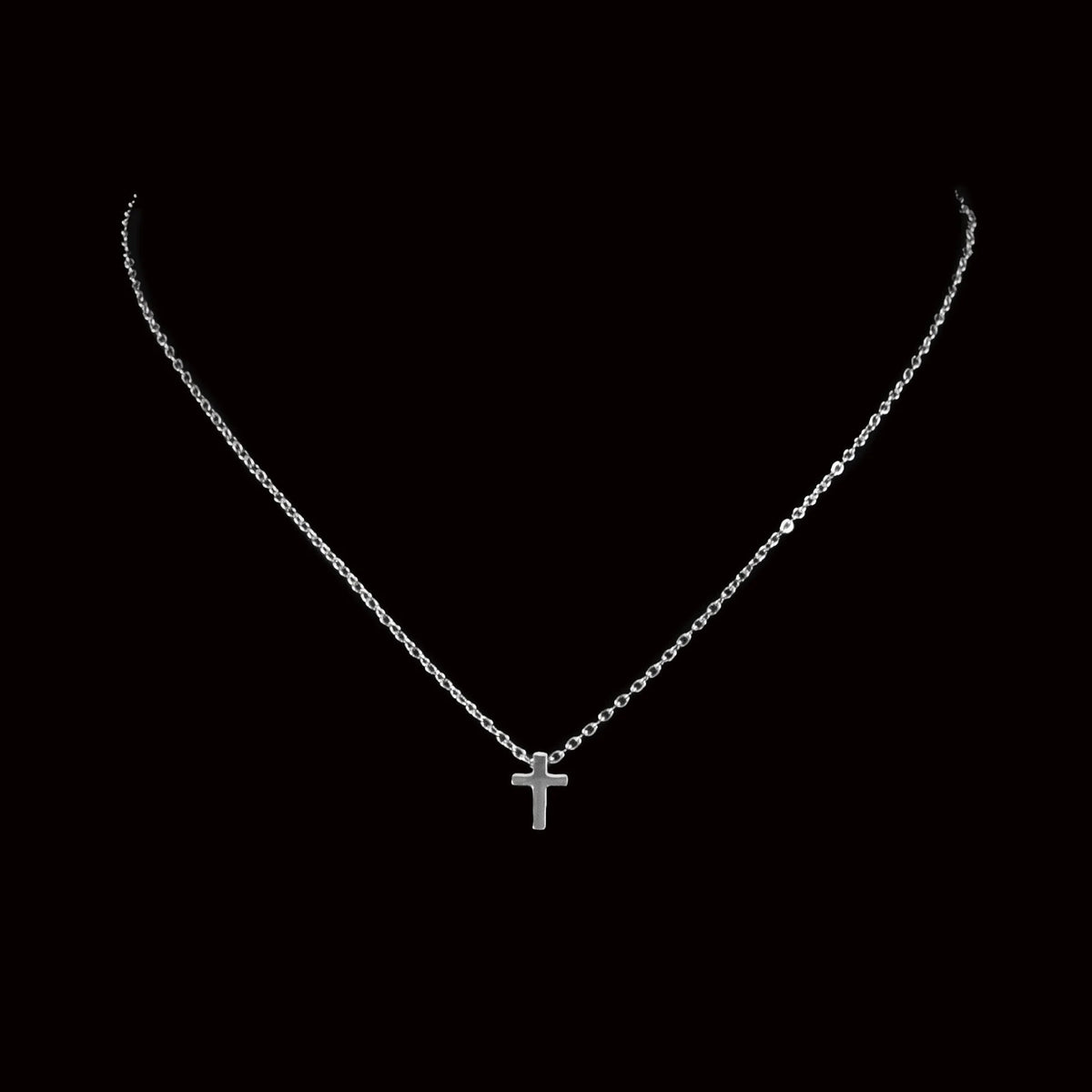 Silver necklace with a small cross pendant.