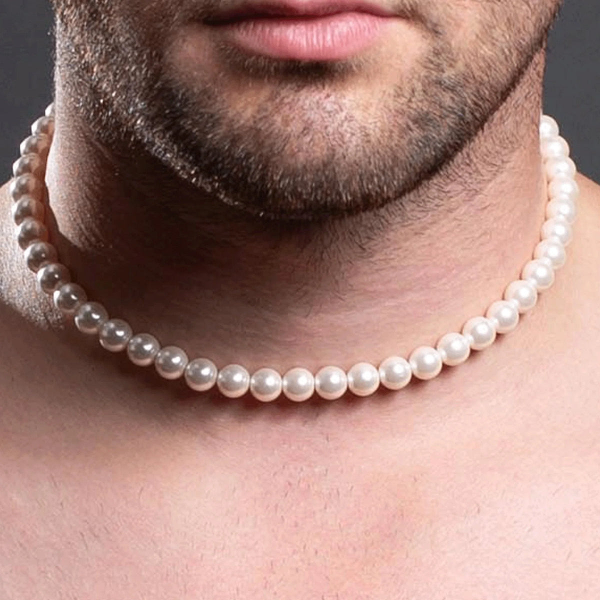 Pearl necklace worn around a person’s neck.