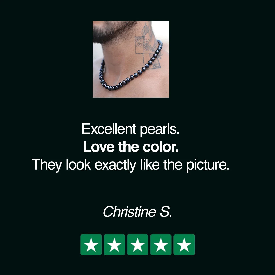 Dark blue pearl necklace worn around a neck.