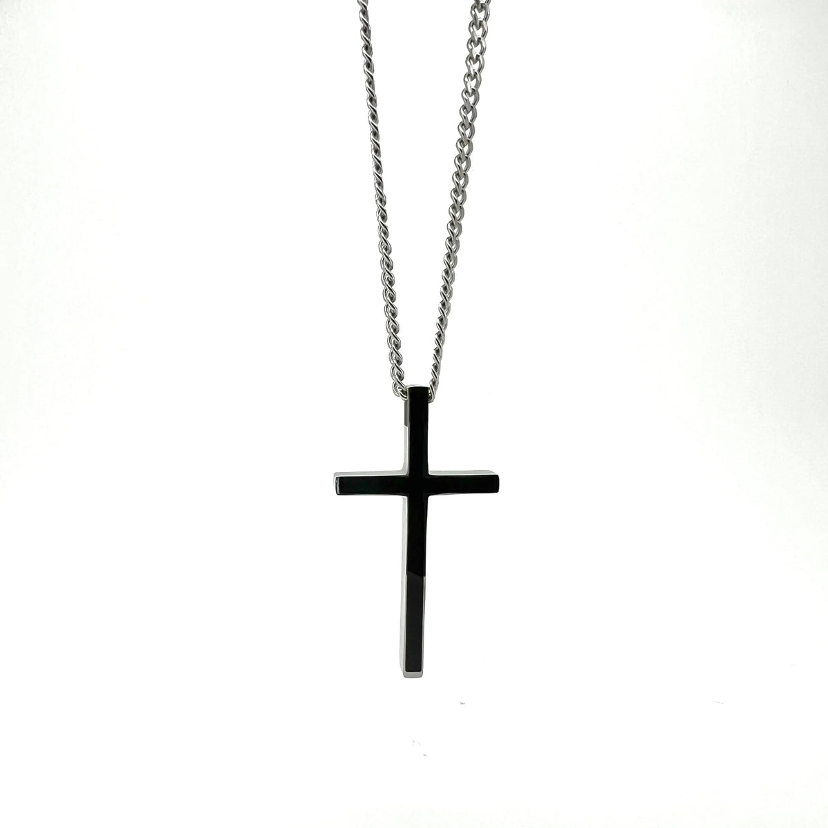 Black cross pendant on a silver chain necklace.