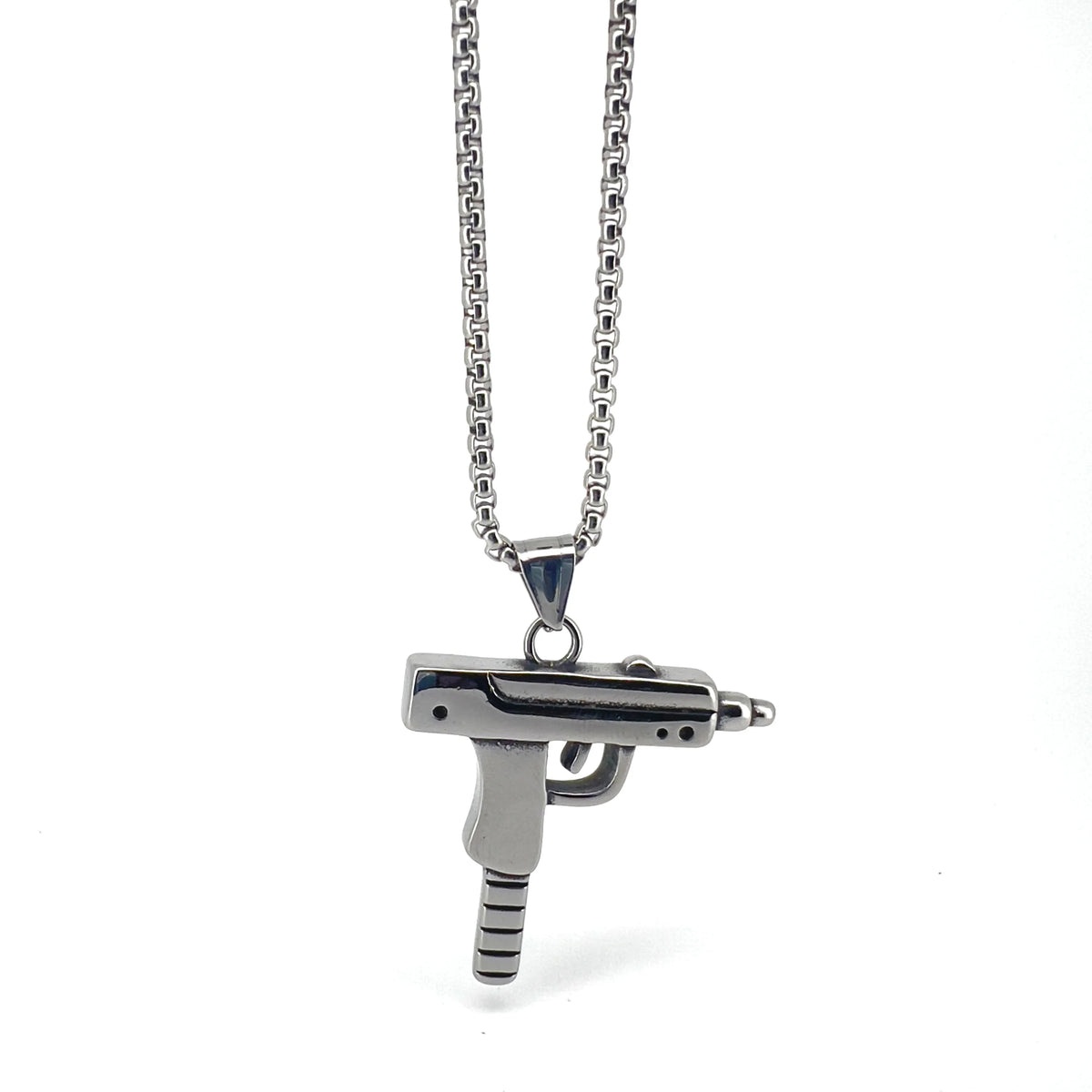 Silver pendant necklace featuring a miniature submachine gun charm.