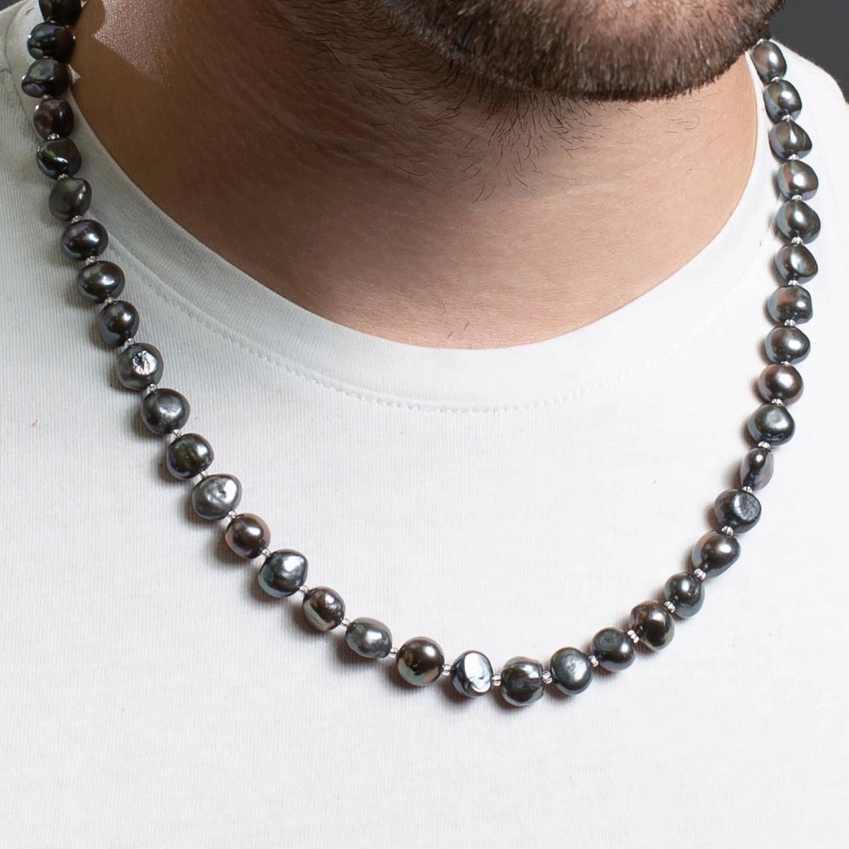 Pearl necklace with dark gray or black pearls.