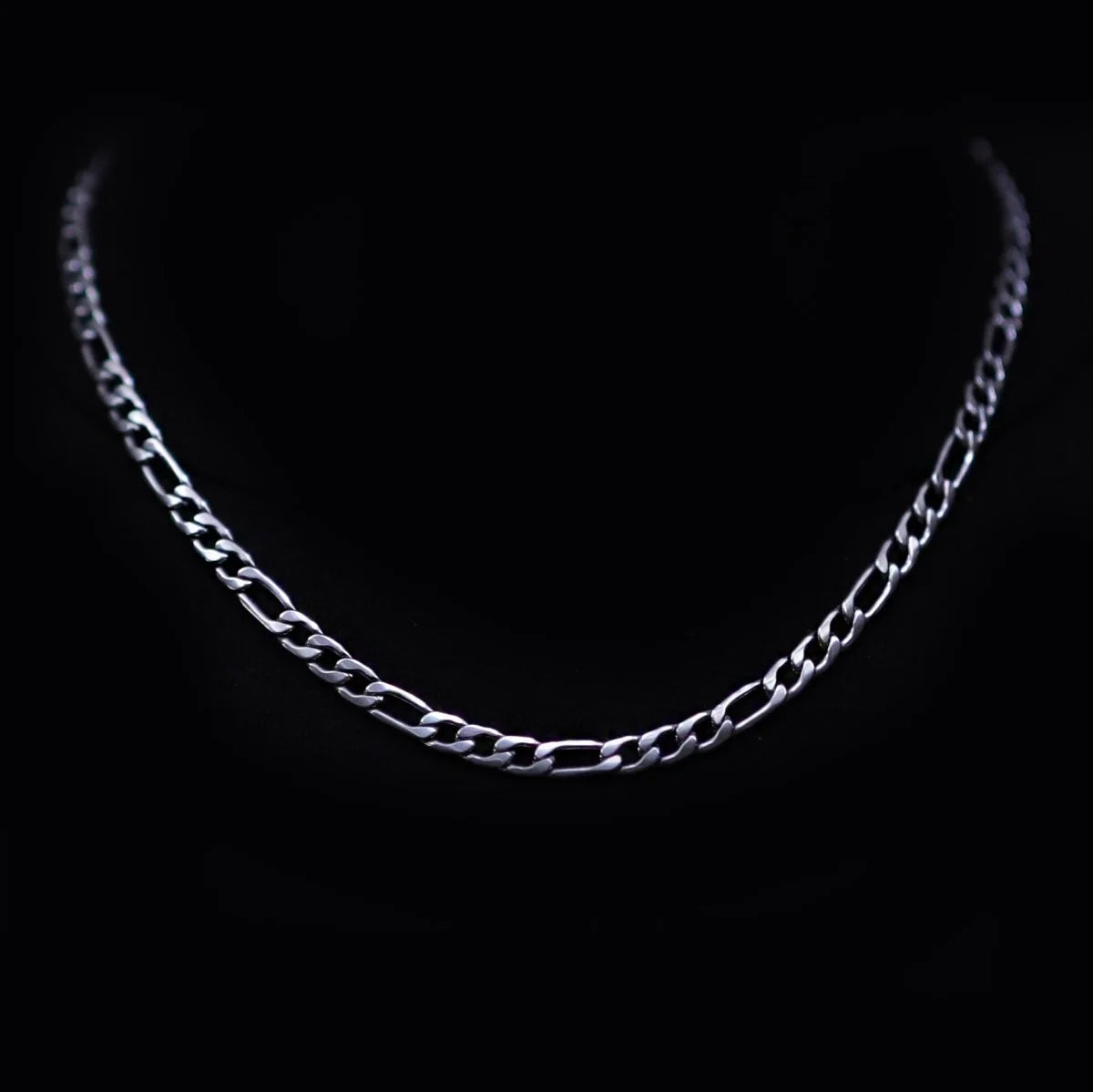 Silver chain necklace with a Figaro link pattern.