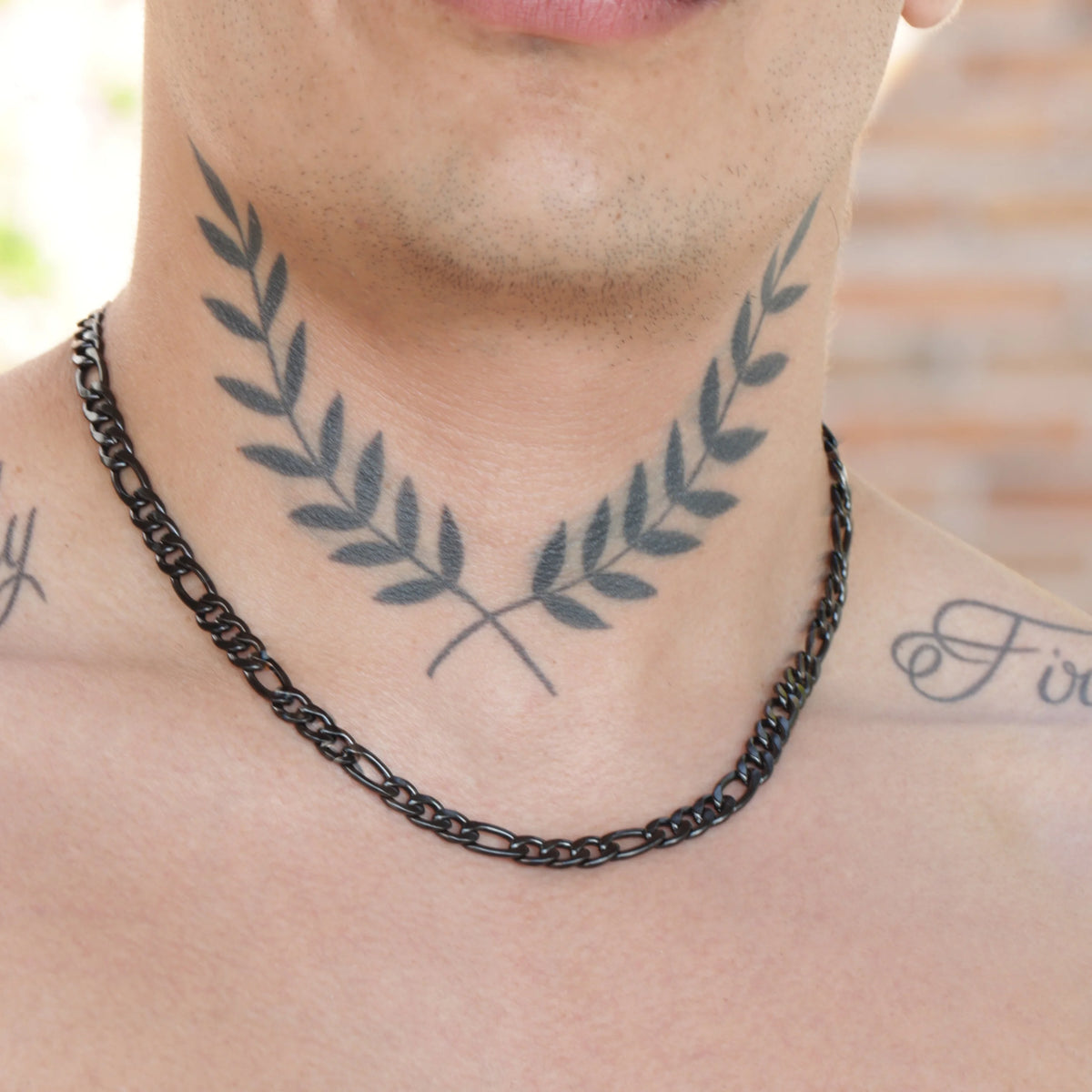 Tattoo of symmetrical olive branches on a person’s neck.