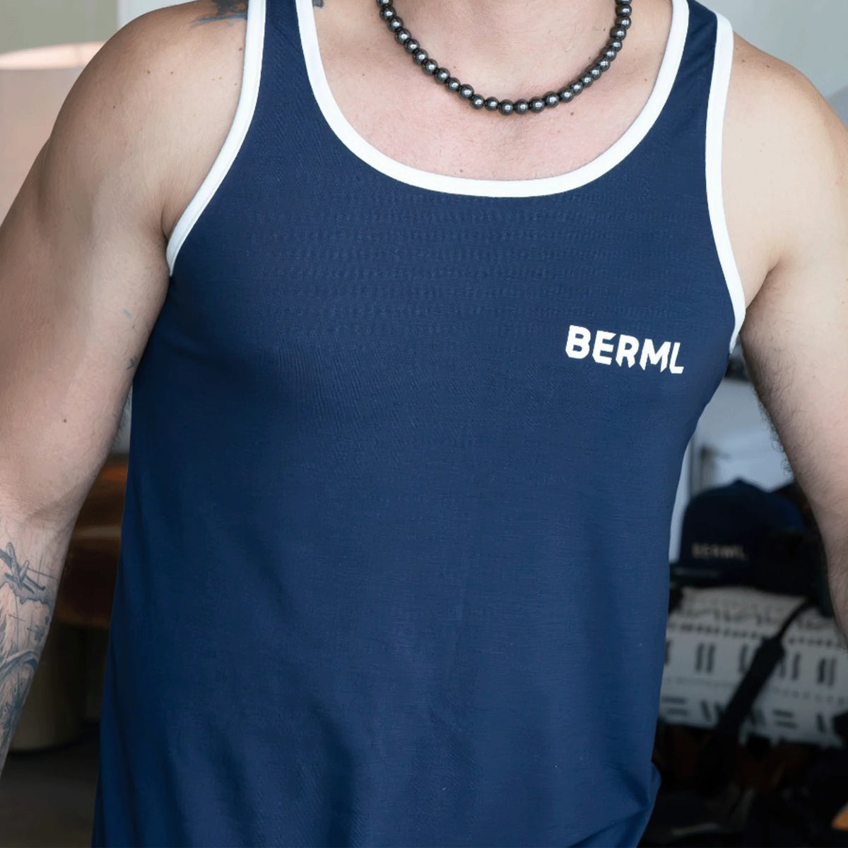 Navy blue tank top with white trim and ’BERML’ printed on the chest.