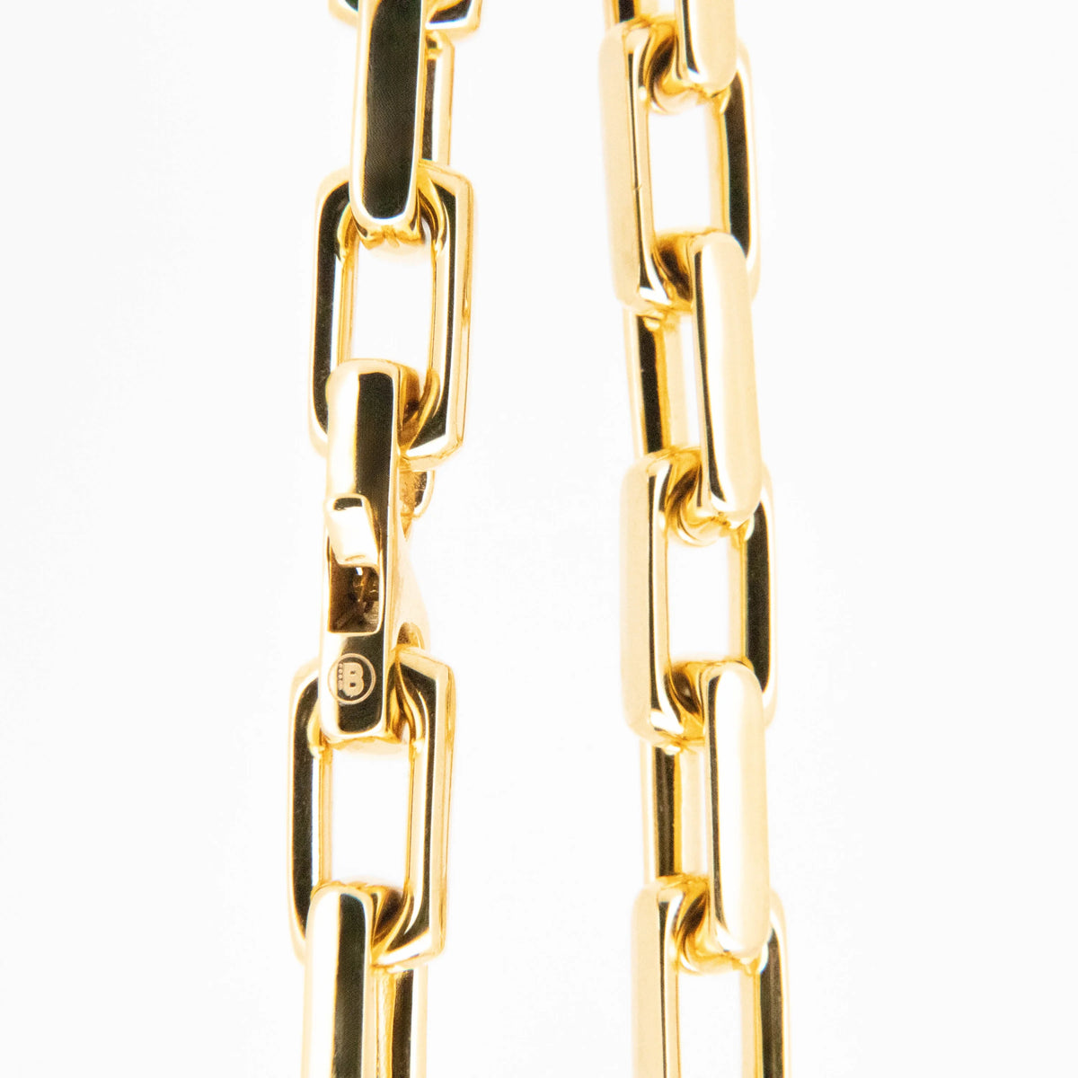 Gold-colored chain links arranged in parallel vertical lines.