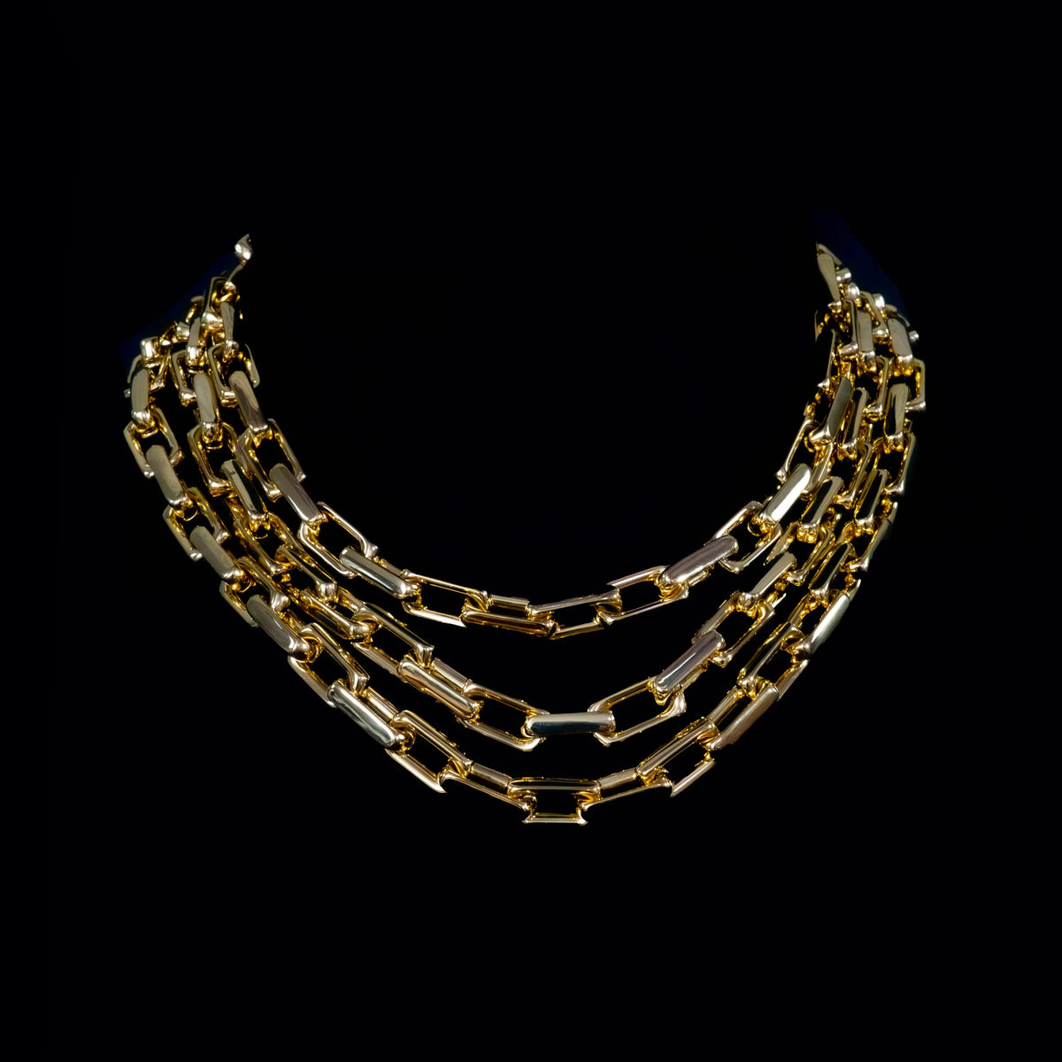 Multi-strand gold chain necklace with rectangular links.