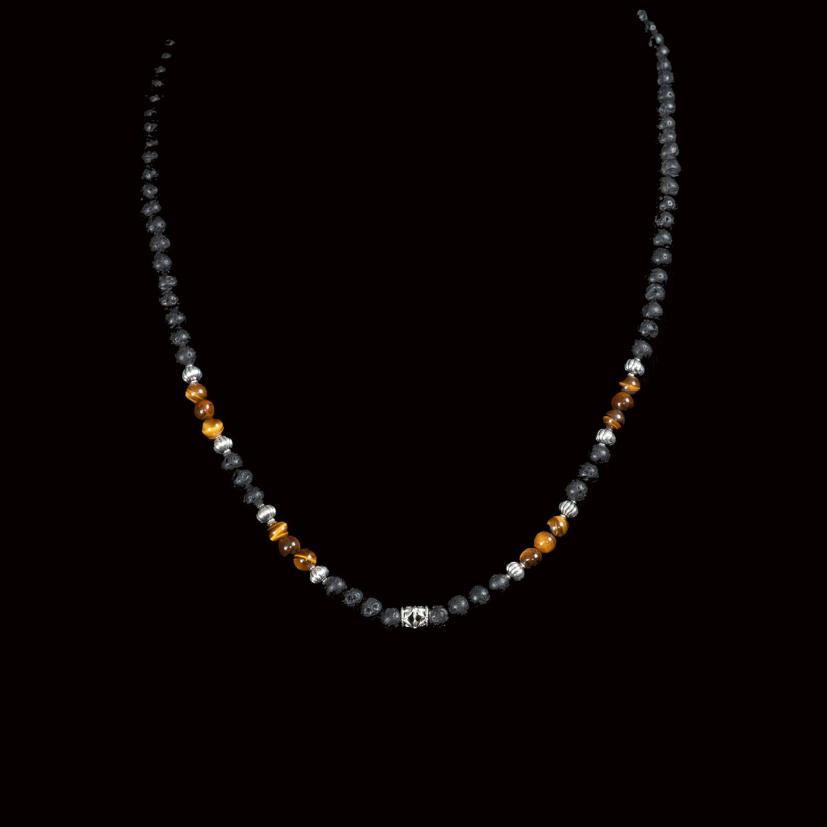 Beaded necklace with black, amber, and silver-colored stones.