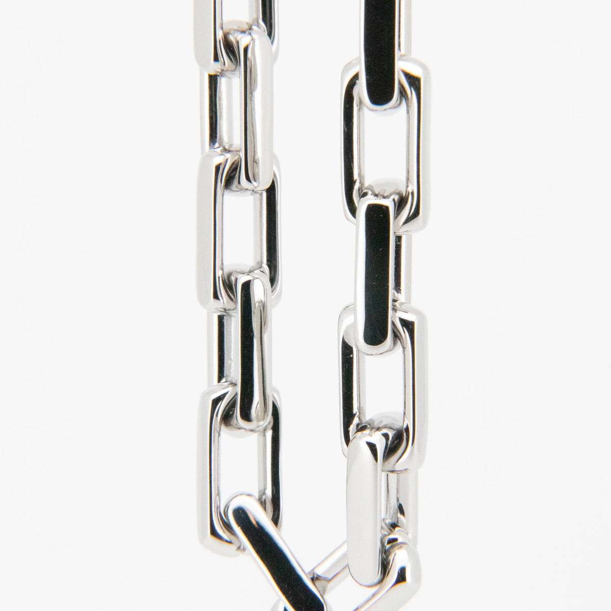 Silver metal chain with rectangular links.