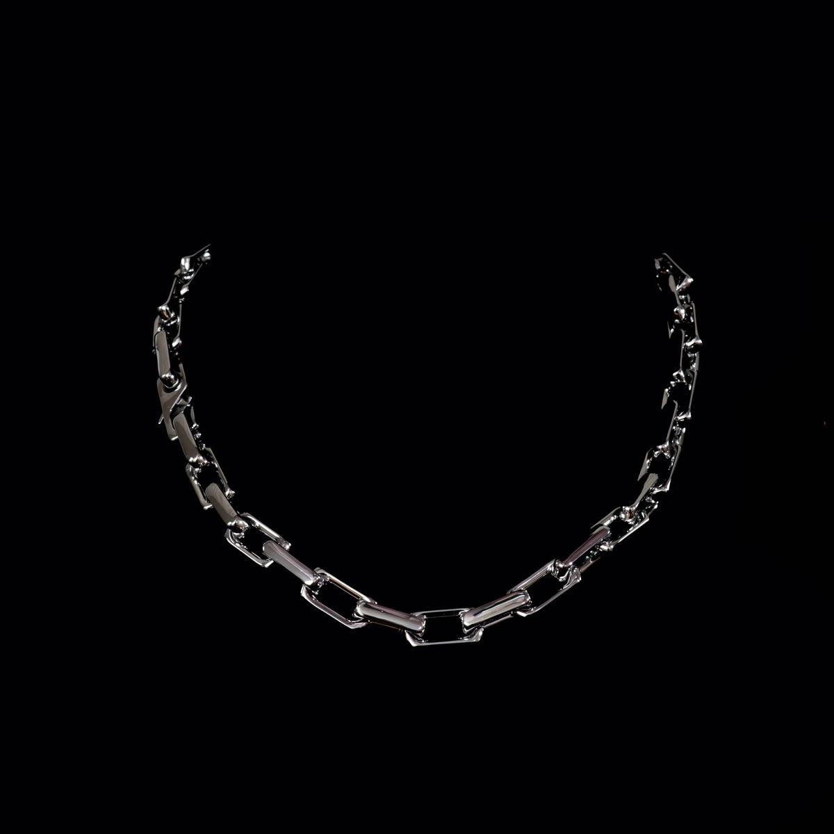 Silver chain necklace with rectangular links.