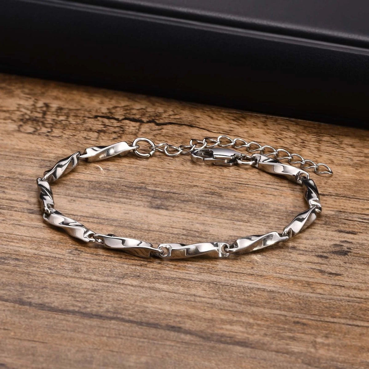 Silver twisted link bracelet with a clasp and extension chain.