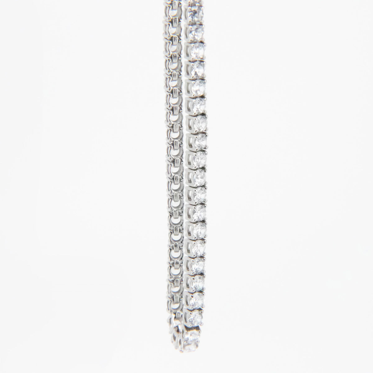 Diamond tennis bracelet with round stones set in white metal.