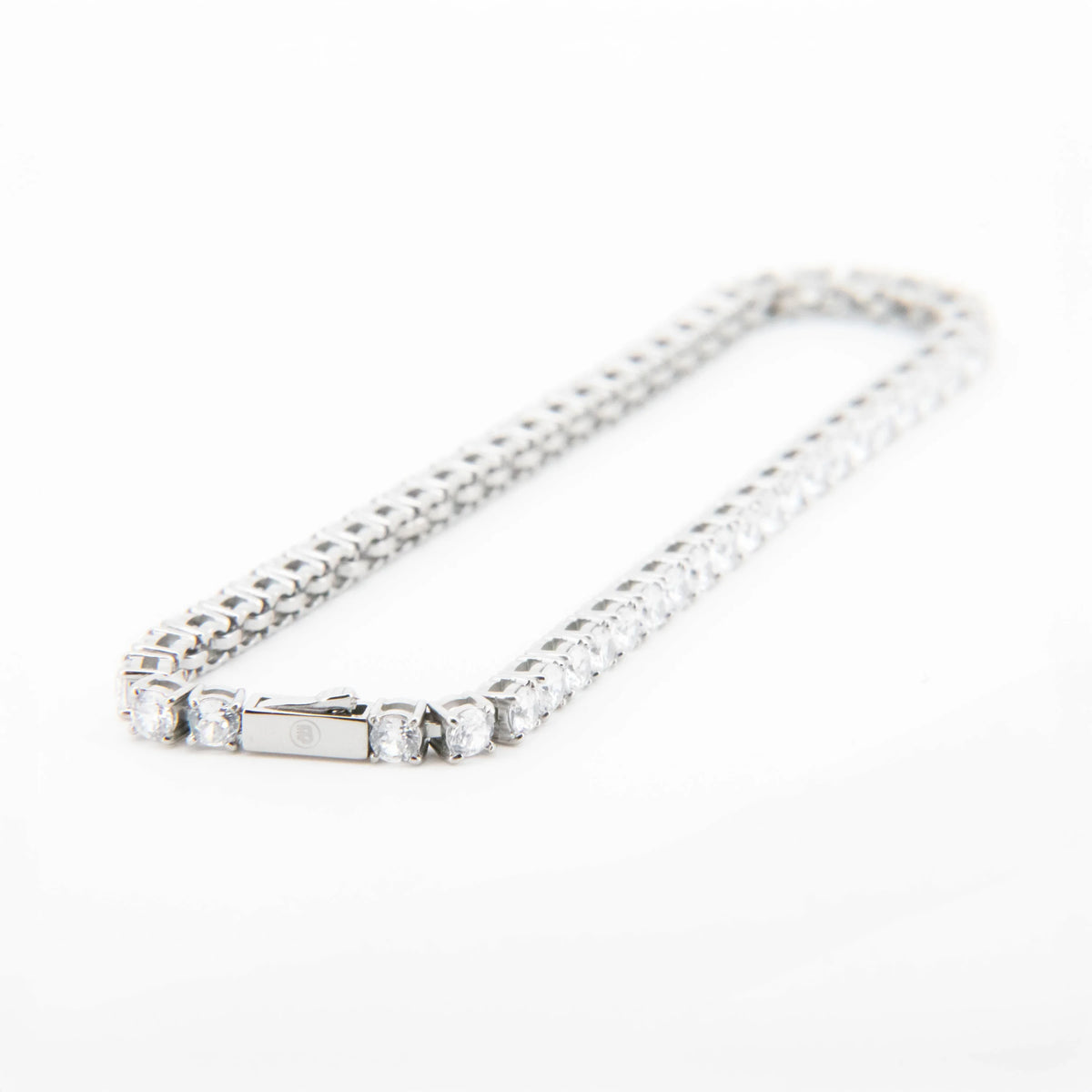 Silver tennis bracelet with alternating round and baguette diamonds.