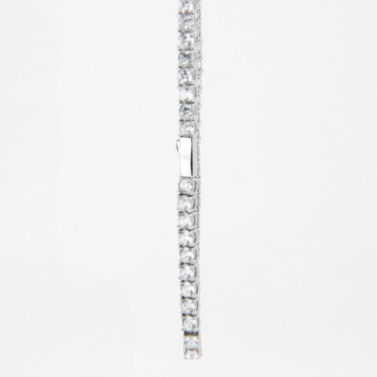 Silver tennis bracelet with clear gemstones set in a line.