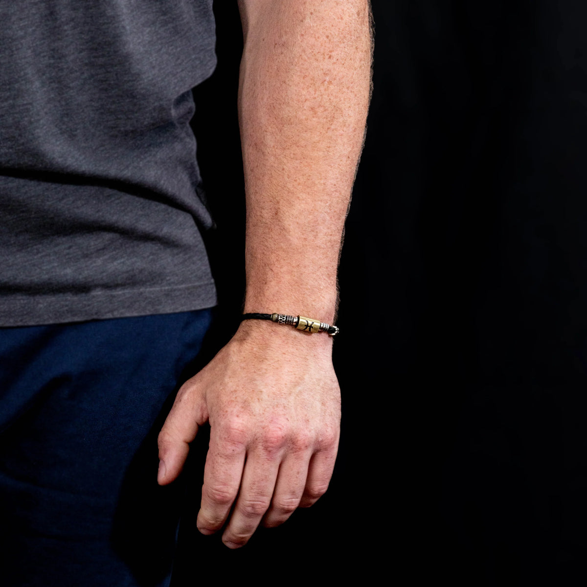 Black beaded bracelet worn on a wrist.