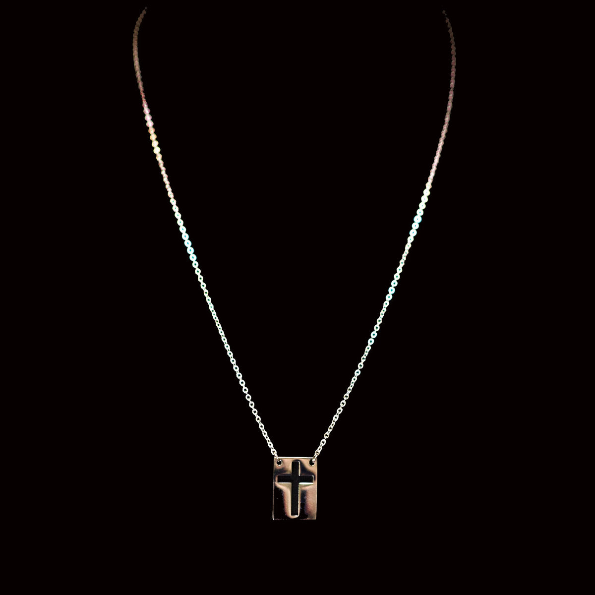 Silver chain necklace with a geometric pendant featuring the letter T.