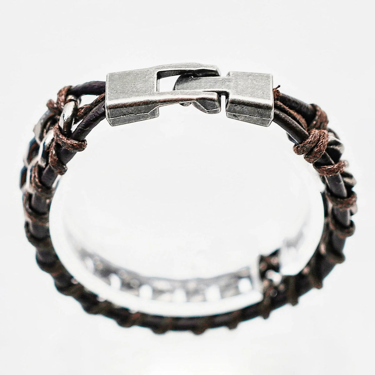 Leather and metal bracelet with a clasp closure.