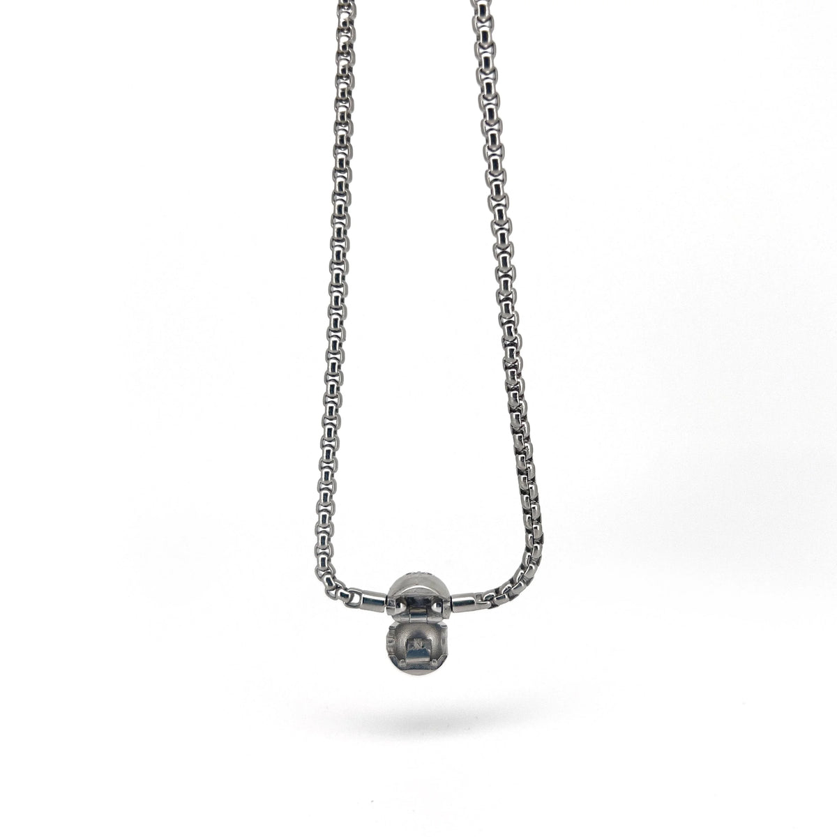 Silver chain necklace with a small spherical pendant.