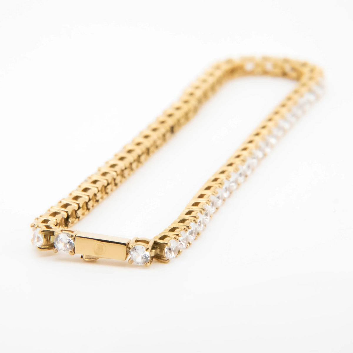 Gold bracelet with diamond accents along one edge.