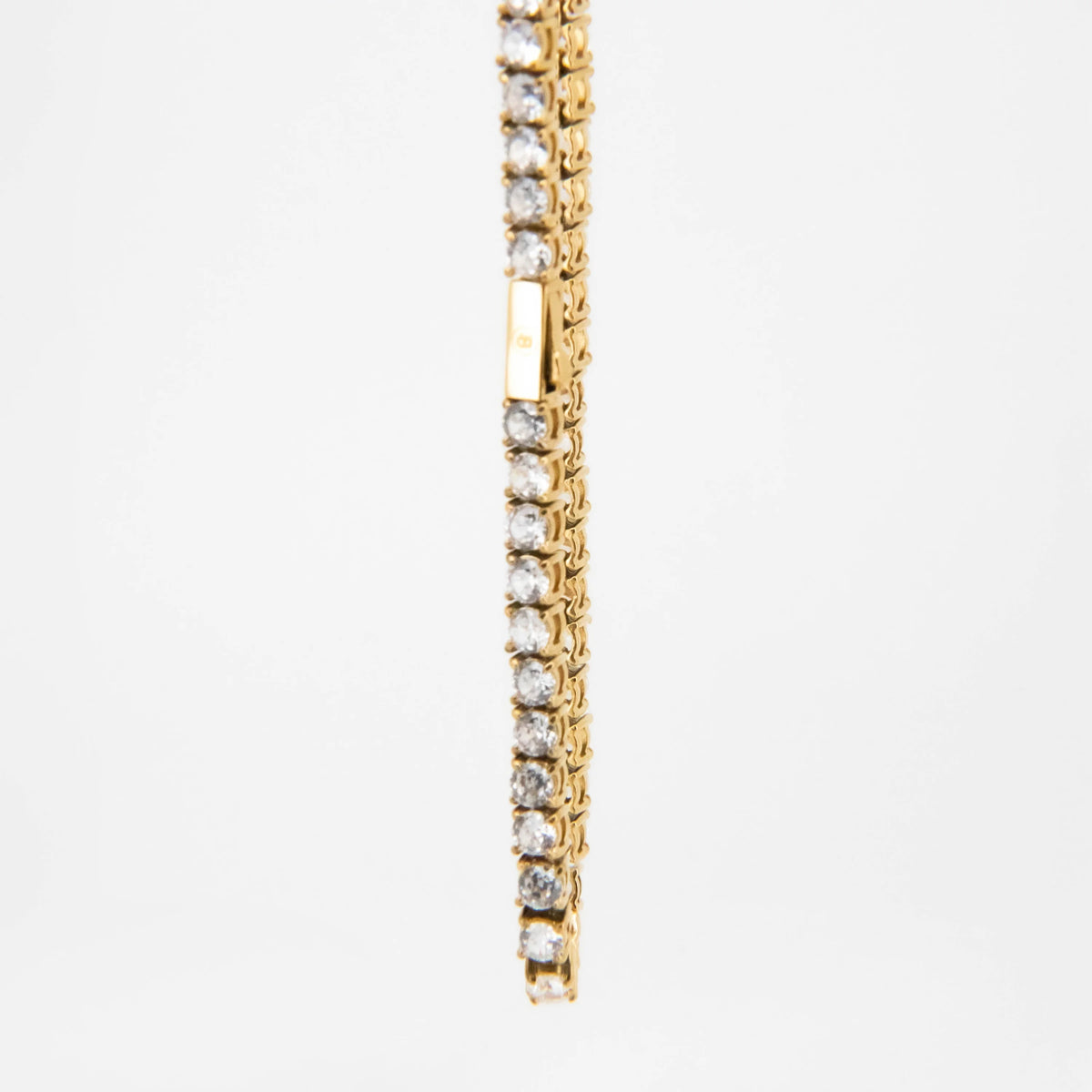 Gold and diamond tennis bracelet with a line of sparkling stones.