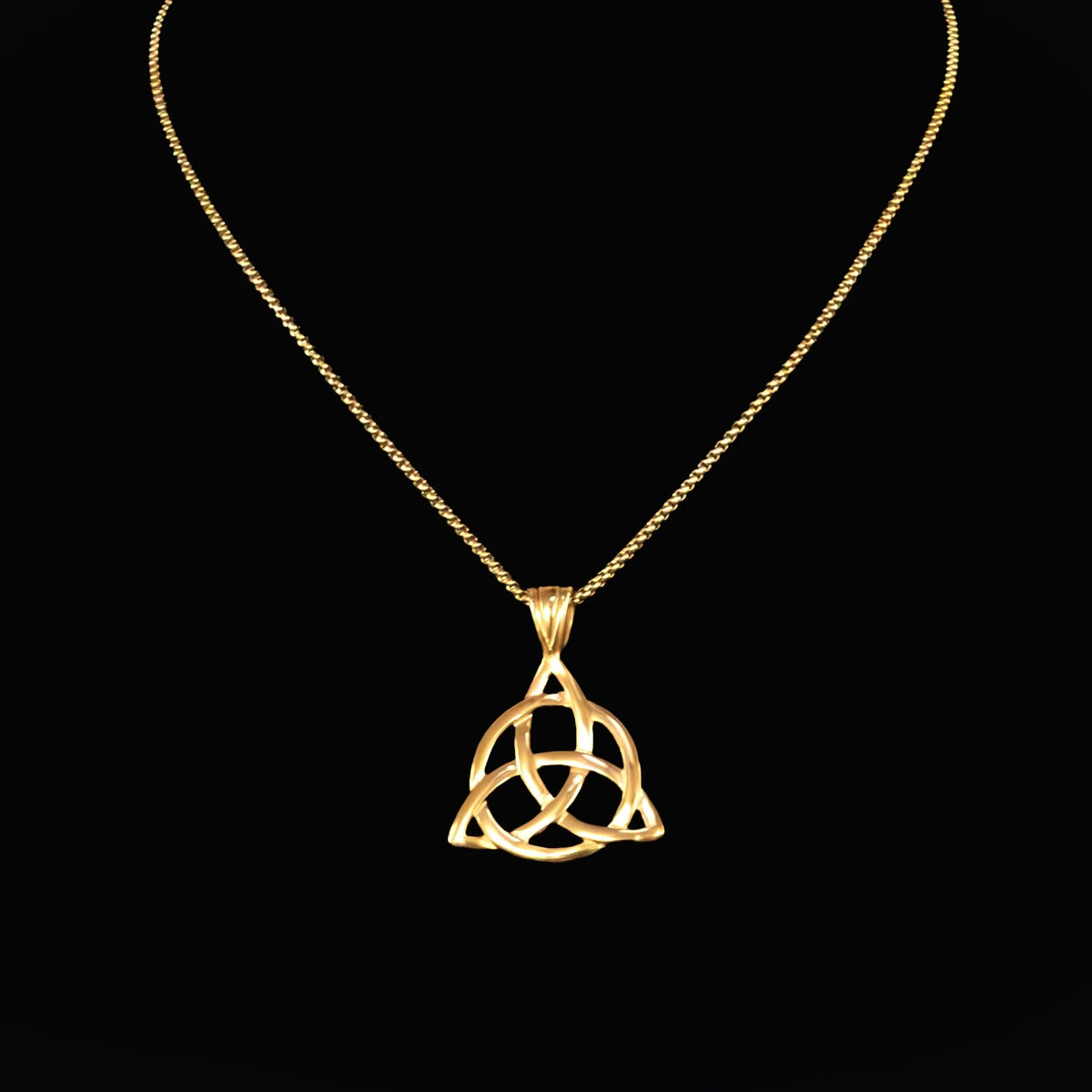 Gold pendant necklace featuring a Celtic triquetra knot design.