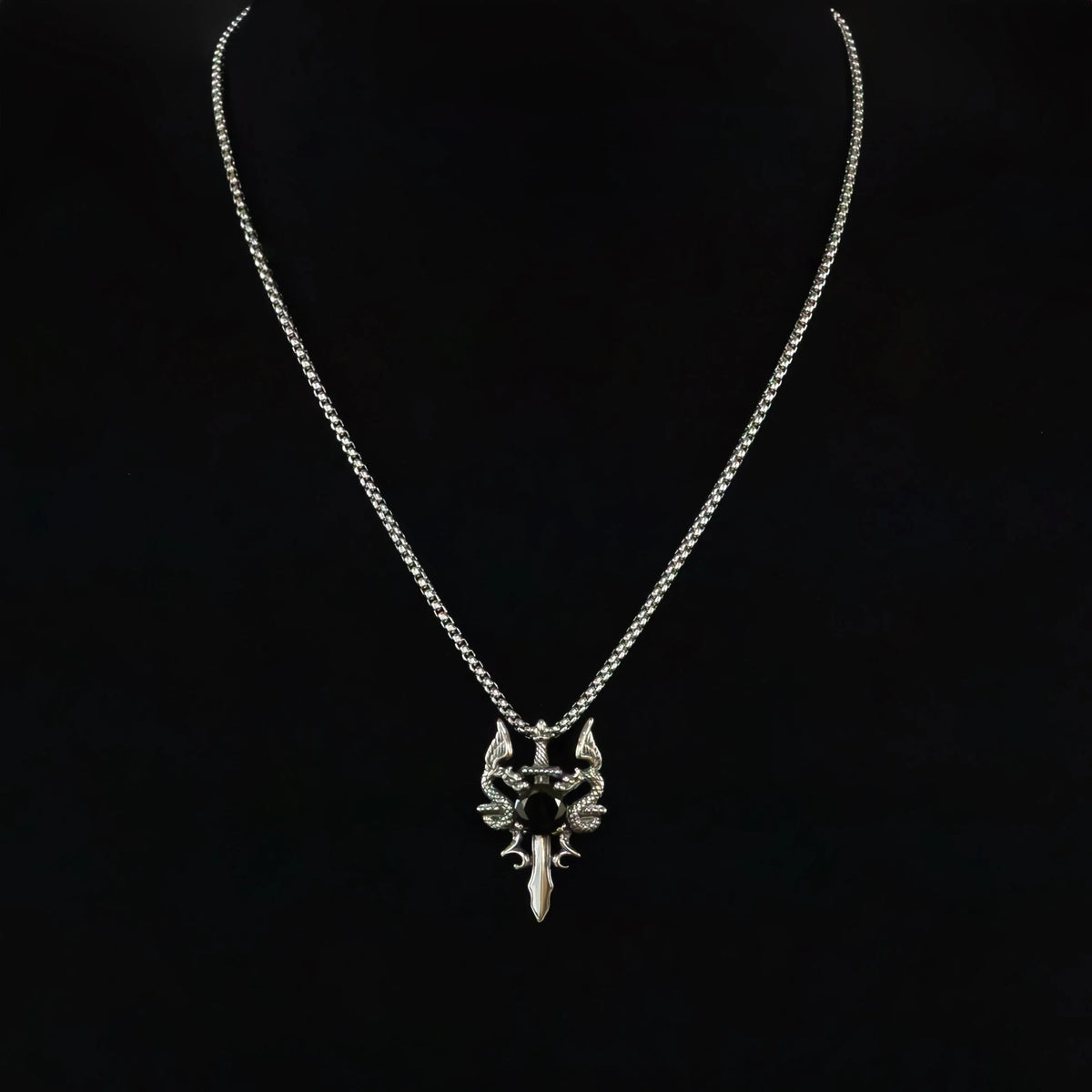 Silver necklace with an intricate sword-shaped pendant.