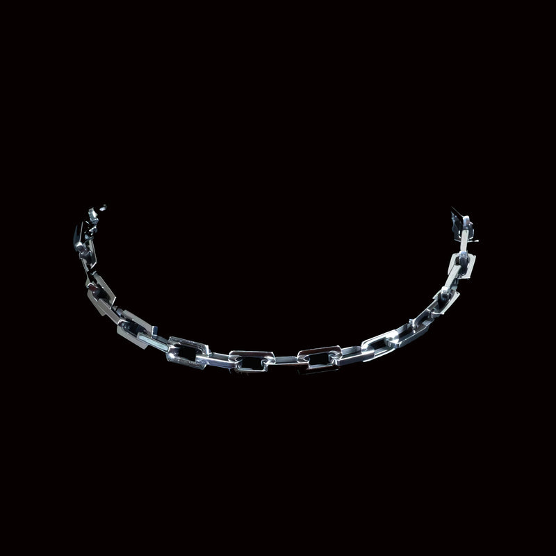 Curved chain of transparent or glass-like links against a black background.