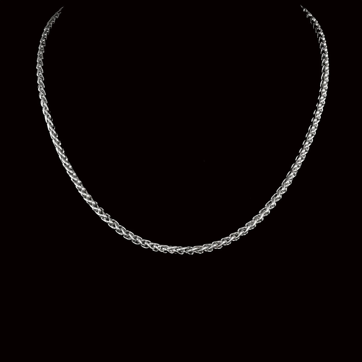 Silver chain necklace with a braided or twisted rope-like pattern.