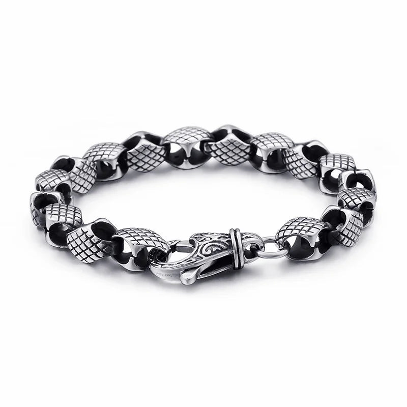 Silver bracelet with alternating textured and smooth beads connected by a decorative clasp.