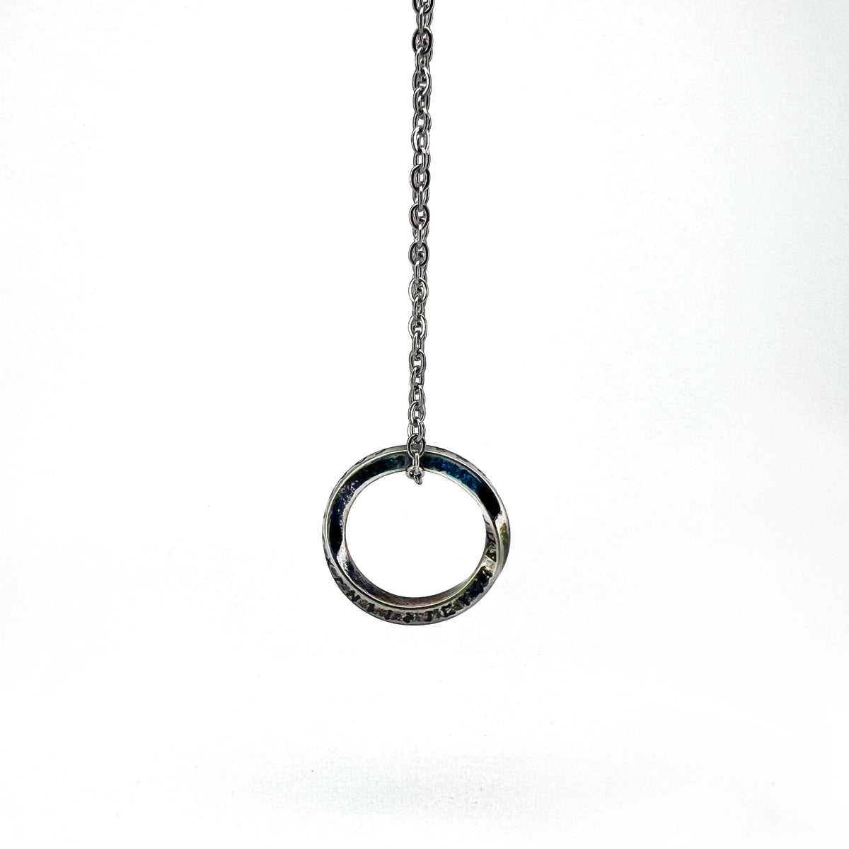 Silver ring pendant hanging from a chain.