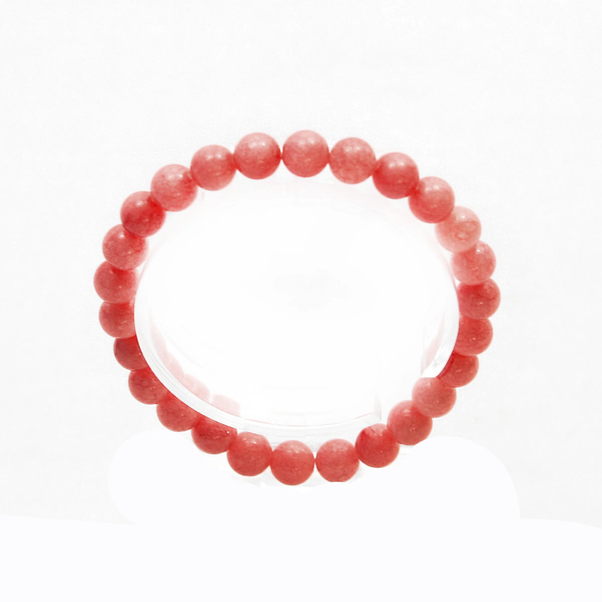 Pink coral bead bracelet with round beads strung together.