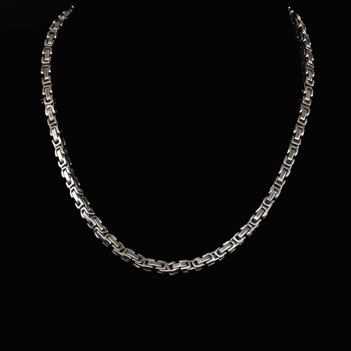 Silver chain necklace with interlocking geometric links.