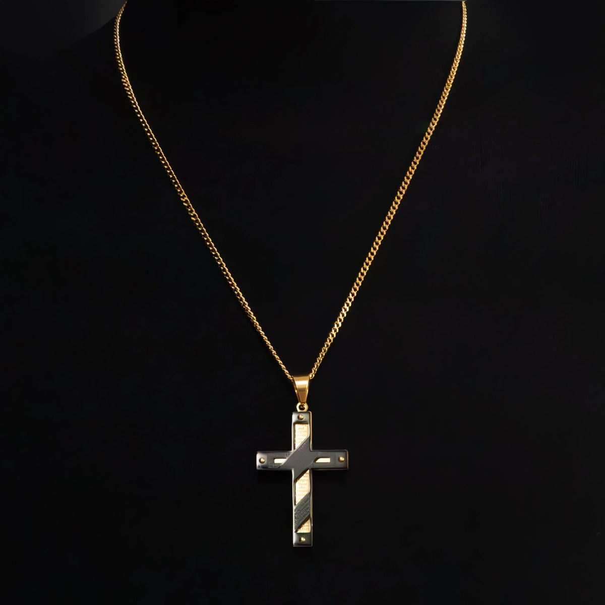 Gold chain necklace with a cross pendant.