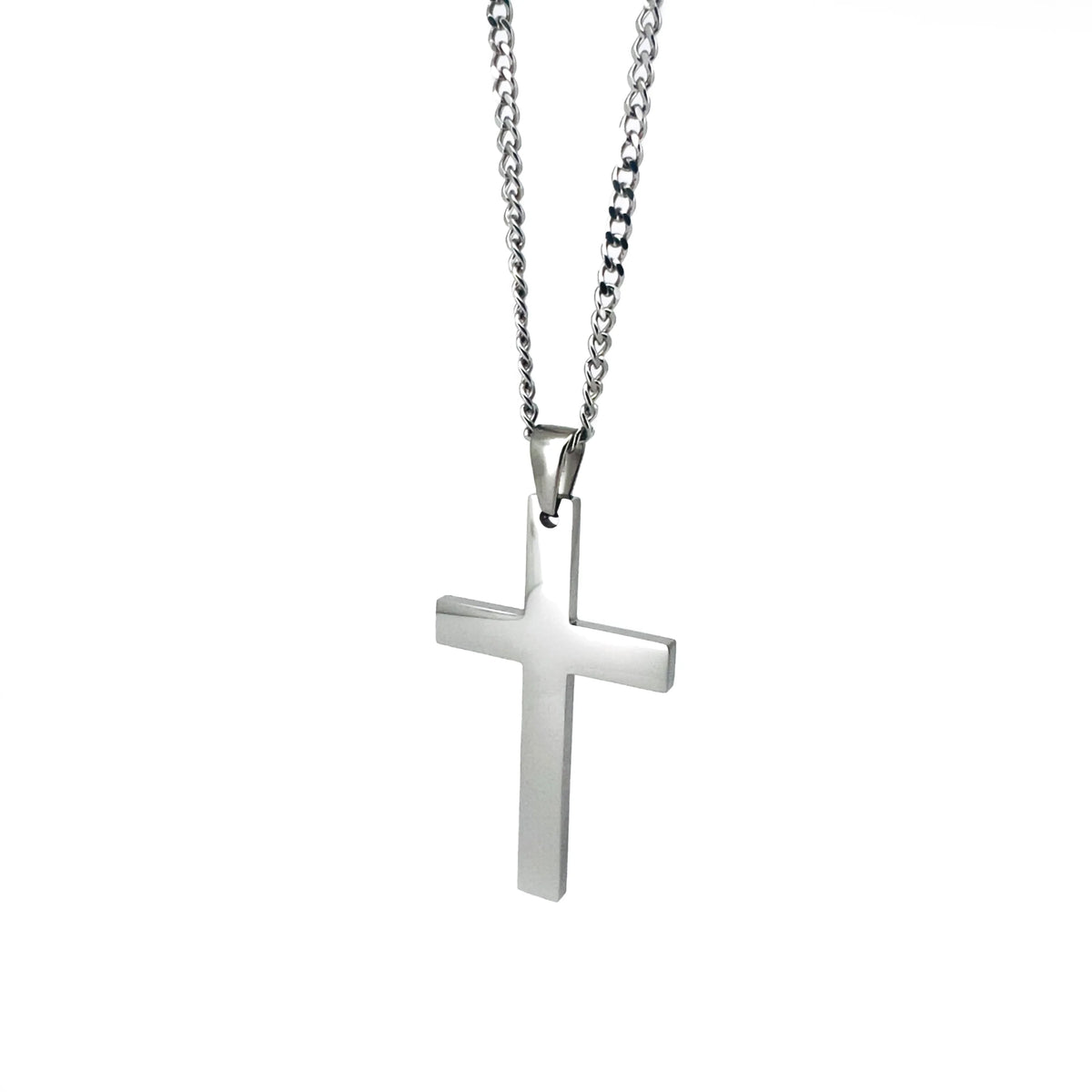 Silver cross pendant on a chain necklace.