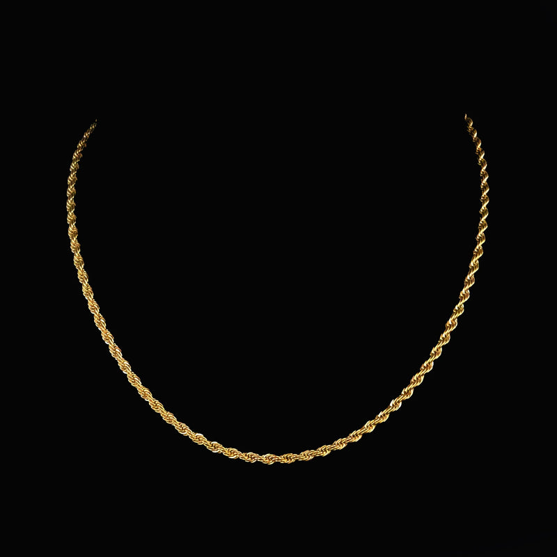 Gold rope chain necklace against a black background.